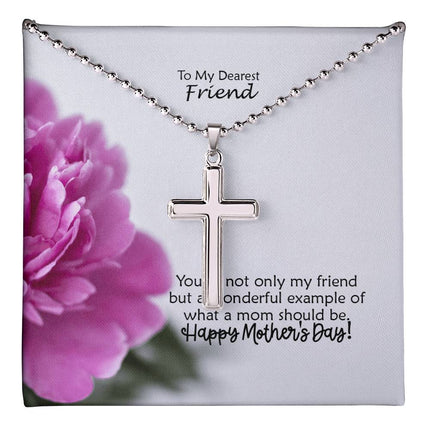 Polished stainless steel cross necklace with ball chain displayed in a mahogany luxury gift box with a To My Dearest Friend Happy Mother's Day message card and pink peony flower background.