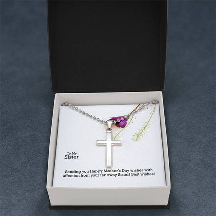 Polished stainless steel cross necklace with ball chain displayed in a luxury gift box with a To My Sister Sending Happy Mother's Day Wishes message card and purple wildflower background.