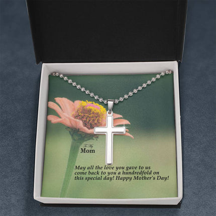 Polished stainless steel cross necklace with ball chain displayed in a luxury gift box with a To My Mom May All the Love You Gave Come Back Hundredfold Happy Mother's Day message card and pink zinnia flower background.