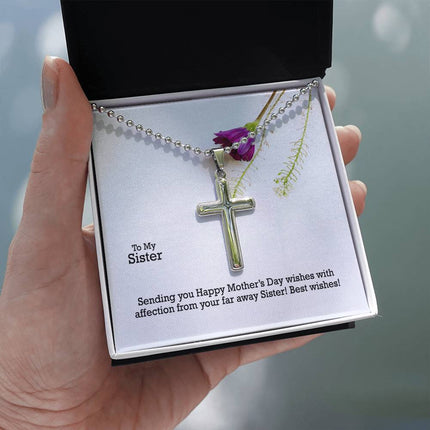 Polished stainless steel cross necklace with ball chain displayed in a luxury gift box with a To My Sister Sending Happy Mother's Day Wishes message card and purple wildflower background.