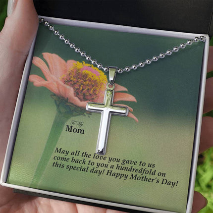 Polished stainless steel cross necklace with ball chain displayed in a luxury gift box with a To My Mom May All the Love You Gave Come Back Hundredfold Happy Mother's Day message card and pink zinnia flower background.