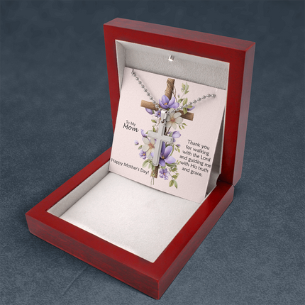 Polished stainless steel cross necklace with ball chain displayed in a mahogany luxury gift box with a To My Mom Thank You for Walking With the Lord Happy Mother's Day message card and purple floral cross background.