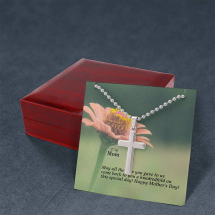 Polished stainless steel cross necklace with ball chain displayed in a luxury gift box with a To My Mom May All the Love You Gave Come Back Hundredfold Happy Mother's Day message card and pink zinnia flower background.