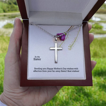 Polished stainless steel cross necklace with ball chain displayed in a luxury gift box with a To My Sister Sending Happy Mother's Day Wishes message card and purple wildflower background.