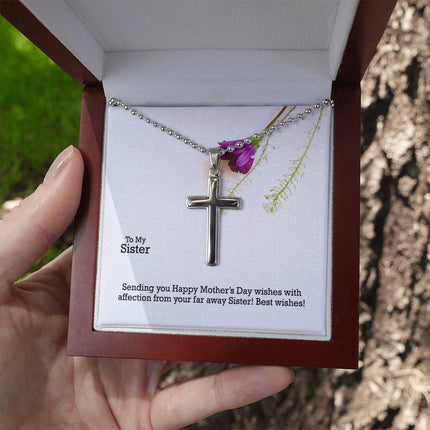 Polished stainless steel cross necklace with ball chain displayed in a luxury gift box with a To My Sister Sending Happy Mother's Day Wishes message card and purple wildflower background.