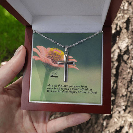 Polished stainless steel cross necklace with ball chain displayed in a luxury gift box with a To My Mom May All the Love You Gave Come Back Hundredfold Happy Mother's Day message card and pink zinnia flower background.