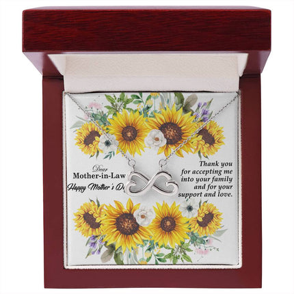 Heart-shaped infinity endless love necklace in white gold finish held in hands, displayed in a gift box with a Dear Mother-in-Law Happy Mother's Day message card and sunflower floral background.