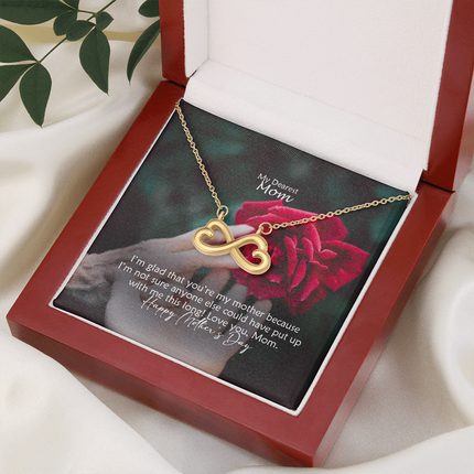 Heart-shaped infinity endless love necklace in white gold finish held in hands, displayed in a gift box with a My Dearest Mom Happy Mother's Day message card and red rose background.
