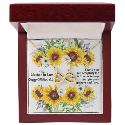 Heart-shaped infinity endless love necklace in white gold finish held in hands, displayed in a gift box with a Dear Mother-in-Law Happy Mother's Day message card and sunflower floral background.