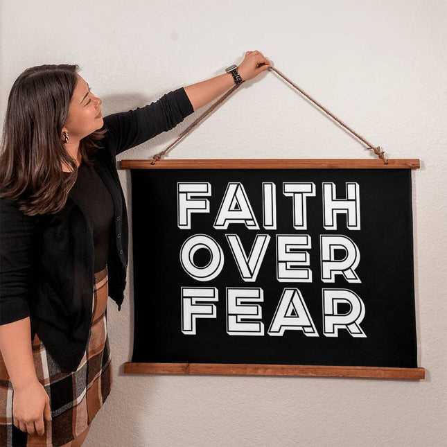 Faith over fear wood framed wall tapestry with bold white outlined block text on black background – 36x26 horizontal Christian wall decor