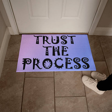 Trust the process welcome mat with decorative black lettering on purple to blue gradient background – faith encouragement doormat