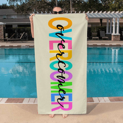 Christian bath towel with overcomer text in multicolor block letters and black script overlay – 60x30 beach and pool towel