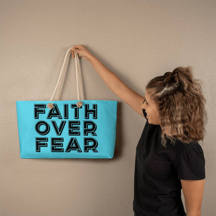 Aqua blue weekender tote bag with “Faith Over Fear” large outlined black lettering – Christian travel tote with rope handles