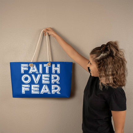 Blue weekender tote bag with “Faith Over Fear” large outlined white lettering – Christian travel tote with rope handles