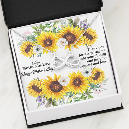Heart-shaped infinity endless love necklace in white gold finish held in hands, displayed in a gift box with a Dear Mother-in-Law Happy Mother's Day message card and sunflower floral background.