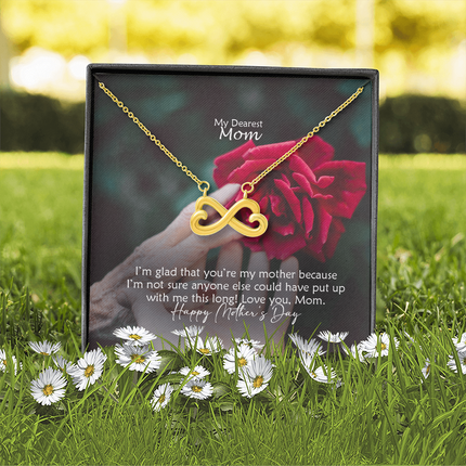 Heart-shaped infinity endless love necklace in white gold finish held in hands, displayed in a gift box with a My Dearest Mom Happy Mother's Day message card and red rose background.