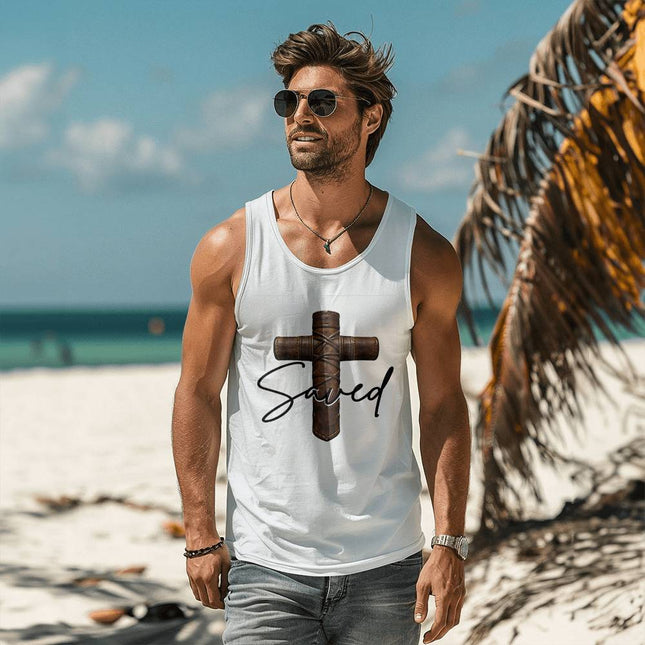Man wearing a white unisex tank top featuring a leather-wrapped stitched cross graphic with the word "Saved" in black script on the front, styled on a sunny beach setting.