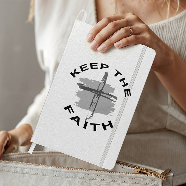 White ambassador bound journal with “Keep the Faith” circular design and cross over gray brush stroke – Christian prayer journal notebook