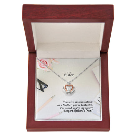 Sterling silver and rose gold crown pendant necklace with a sparkling cubic zirconia center, displayed in a mahogany luxury LED gift box with a To My Sister Happy Mother's Day message card.
