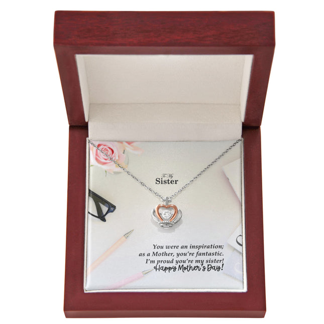 Sterling silver and rose gold crown pendant necklace with a sparkling cubic zirconia center, displayed in a mahogany luxury LED gift box with a To My Sister Happy Mother's Day message card.