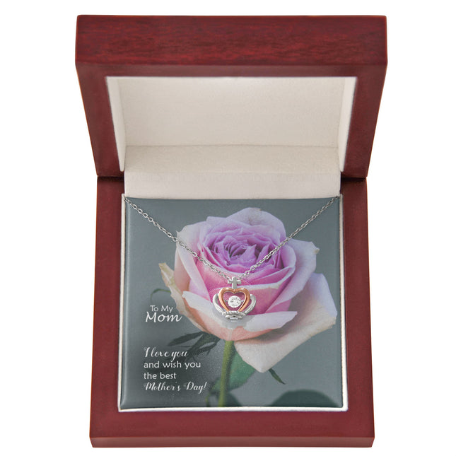 Sterling silver and rose gold crown pendant necklace with a sparkling cubic zirconia center, displayed in a mahogany luxury LED gift box with a To My Mom I Love You Happy Mother's Day message card and a pink rose background.